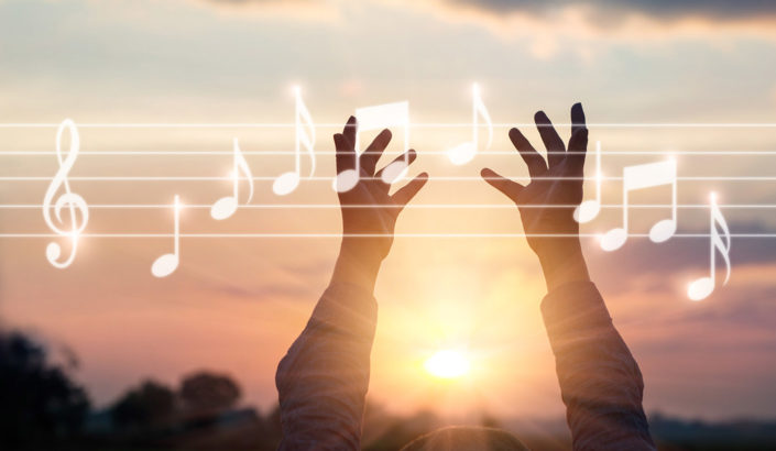 Hands touching musing notes in the sky