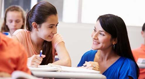 A teacher guiding a student