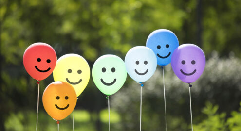 Balloons with smiley faces representing kindness and happiness