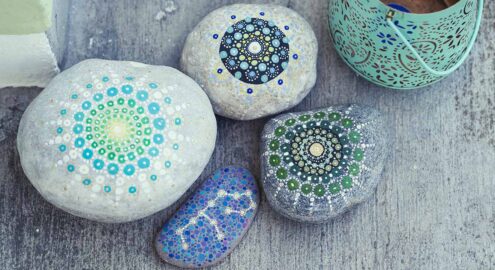four stones painted with mandalas